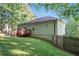 Side view of the home features a deck, grassy yard, and wooden perimeter fence at 260 Sterling Dr, Powder Springs, GA 30127