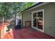 A view of a deck with a grill that leads to a green, tree-filled backyard at 260 Sterling Dr, Powder Springs, GA 30127