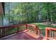 Backyard features a red wood deck that steps down to a manicured, grassy yard at 260 Sterling Dr, Powder Springs, GA 30127