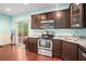 Modern kitchen featuring stainless steel appliances, dark cabinets, and marble countertops at 260 Sterling Dr, Powder Springs, GA 30127