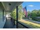 View from the covered porch, showcasing an American flag and serene neighborhood at 260 Sterling Dr, Powder Springs, GA 30127