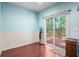 A room with hardwood floors and sliding glass doors to the backyard deck at 260 Sterling Dr, Powder Springs, GA 30127