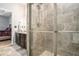 Shower featuring stone tile and glass door, with bathroom sink/vanity in the background at 260 Sterling Dr, Powder Springs, GA 30127