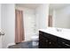 Bathroom with a shower over the tub, a dark cabinet and a plush gray rug at 3080 W Jackson Way, Austell, GA 30106