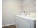 Laundry room with vinyl floors, a wire rack and new, white, front-loading machines at 3080 W Jackson Way, Austell, GA 30106