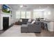 Open-concept living room with a fireplace, built-in shelves, and seamless flow to the kitchen at 3080 W Jackson Way, Austell, GA 30106