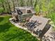 Aerial shot of gambrel roof home featuring a well-manicured lawn, carport, and mature trees at 3125 Lakeside Dr, Cumming, GA 30041