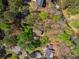 Aerial view of home surrounded by mature trees, lush greenery, and waterfront access with boat docks at 3125 Lakeside Dr, Cumming, GA 30041