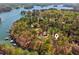 Lakefront property with lush trees, featuring docks and boats, perfect for nature lovers and adventurers at 3125 Lakeside Dr, Cumming, GA 30041