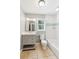 Bright bathroom features a single sink vanity and white tiled shower-tub combo with a window at 3125 Lakeside Dr, Cumming, GA 30041