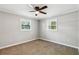 Cozy bedroom features neutral walls, plush carpet, and two bright windows at 3125 Lakeside Dr, Cumming, GA 30041