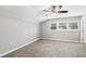 Spacious bedroom with neutral carpet, three windows allowing natural light and a ceiling fan at 3125 Lakeside Dr, Cumming, GA 30041