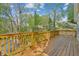 Large wooden deck overlooks a wooded backyard offering a great space for outdoor relaxation and entertaining at 3125 Lakeside Dr, Cumming, GA 30041