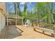 Expansive wooden deck featuring an outdoor fireplace, built-in seating, and a covered gazebo area at 3125 Lakeside Dr, Cumming, GA 30041
