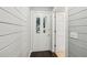 Bright entryway featuring a stylish door with glass inserts and white shiplap walls at 3125 Lakeside Dr, Cumming, GA 30041