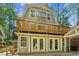 Charming multi-story home showcasing the exterior with a spacious deck for enjoying outdoor living at 3125 Lakeside Dr, Cumming, GA 30041
