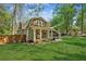 Charming two-story home with a lush green lawn, a covered porch and a fenced backyard at 3125 Lakeside Dr, Cumming, GA 30041