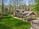 Beautiful home featuring a lush lawn, a covered porch, a porte-cochere and mature trees at 3125 Lakeside Dr, Cumming, GA 30041