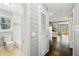 Bright hallway featuring hardwood floors leading to an updated bathroom and kitchen at 3125 Lakeside Dr, Cumming, GA 30041