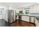 Spacious kitchen with stainless steel appliances, white cabinets, and dark hardwood floors at 3125 Lakeside Dr, Cumming, GA 30041