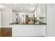 Kitchen with dark countertops, stainless appliances, and a breakfast bar at 3125 Lakeside Dr, Cumming, GA 30041