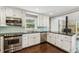 Modern kitchen with stainless steel appliances, white cabinets, and stylish tile backsplash at 3125 Lakeside Dr, Cumming, GA 30041