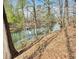 Scenic view of the lake surrounded by lush trees and vegetation at 3125 Lakeside Dr, Cumming, GA 30041