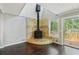 Vaulted living room features a stone fireplace, hardwood floors, and access to deck at 3125 Lakeside Dr, Cumming, GA 30041