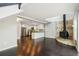 Living room with an open concept to the modern kitchen and a cozy stone fireplace at 3125 Lakeside Dr, Cumming, GA 30041