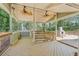 Spacious outdoor deck with gazebo structure, fans, and stone fireplace perfect for outdoor lounging and relaxation at 3125 Lakeside Dr, Cumming, GA 30041