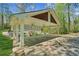 Spacious porte-cochere featuring white columns and a shingled roof offers ample covered parking and easy access at 3125 Lakeside Dr, Cumming, GA 30041