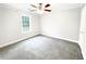 Bright bedroom with plush carpeting, ceiling fan, and a sunlit window at 1206 Park Place Dr, Jonesboro, GA 30236
