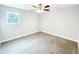 Bright bedroom with plush carpeting, ceiling fan, and a sunlit window at 1206 Park Place Dr, Jonesboro, GA 30236
