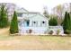 Charming two-story home featuring light green siding, well-manicured landscaping, and a welcoming front porch at 1206 Park Place Dr, Jonesboro, GA 30236