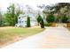 Spacious home with a long drive and well-maintained lawn, set amongst mature trees and natural surroundings at 1206 Park Place Dr, Jonesboro, GA 30236
