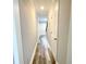 Long hallway featuring hard surface floors and white doors at 1206 Park Place Dr, Jonesboro, GA 30236