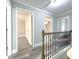 Upstairs hallway boasting neutral walls and flooring with natural light at 1206 Park Place Dr, Jonesboro, GA 30236