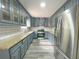 Modern kitchen featuring gray cabinets, granite countertops, stainless steel appliances, and stylish subway tile backsplash at 1206 Park Place Dr, Jonesboro, GA 30236