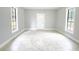 Bright room with two windows and a white door, enhanced by neutral walls and stylish tiled flooring at 1206 Park Place Dr, Jonesboro, GA 30236