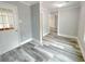 Neutral living room with gray walls, white trim, and modern wood-look flooring, with a glass door at 1206 Park Place Dr, Jonesboro, GA 30236