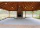 Covered outdoor patio area with brick fireplace and gravel flooring at 1206 Park Place Dr, Jonesboro, GA 30236