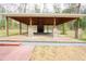 Open patio with brick fireplace and wooden beamed ceiling perfect for outdoor relaxation at 1206 Park Place Dr, Jonesboro, GA 30236
