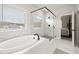 This primary bath is luxurious with a free-standing soaking tub and glass shower with black trim at 3265 Lions Ruby Ln, Atlanta, GA 30349