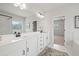 Primary bath vanity featuring dual sinks, marble tile, and black fixtures at 3265 Lions Ruby Ln, Atlanta, GA 30349