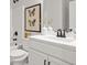 Bathroom featuring white vanity, quartz countertop, framed butterfly art and a shower-tub combo at 3265 Lions Ruby Ln, Atlanta, GA 30349