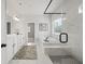 A luxurious primary bath includes a marble-tiled shower and free-standing soaking tub at 3265 Lions Ruby Ln, Atlanta, GA 30349