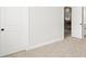 This bedroom features neutral carpet and paint, with doors to other rooms, creating a connected and versatile living area at 3265 Lions Ruby Ln, Atlanta, GA 30349