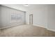 This bedroom features neutral carpet and paint, and a window, providing a serene and bright space at 3265 Lions Ruby Ln, Atlanta, GA 30349