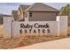 Attractive Ruby Creek Estates entrance sign built of painted white brick in a landscaped setting at 3265 Lions Ruby Ln, Atlanta, GA 30349
