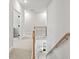 Upstairs hallway with wood and iron railing and a view of the foyer below at 3265 Lions Ruby Ln, Atlanta, GA 30349